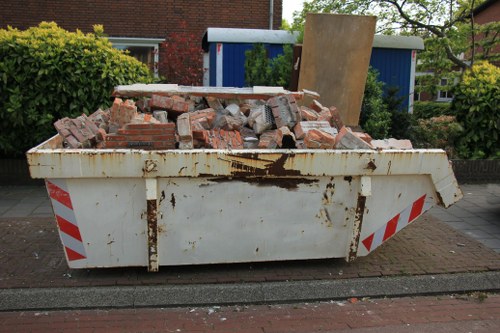 A large skip container placed in a residential area in Hainault.