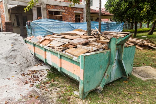 Eco-friendly skip hire service in Hainault with recycling labels.